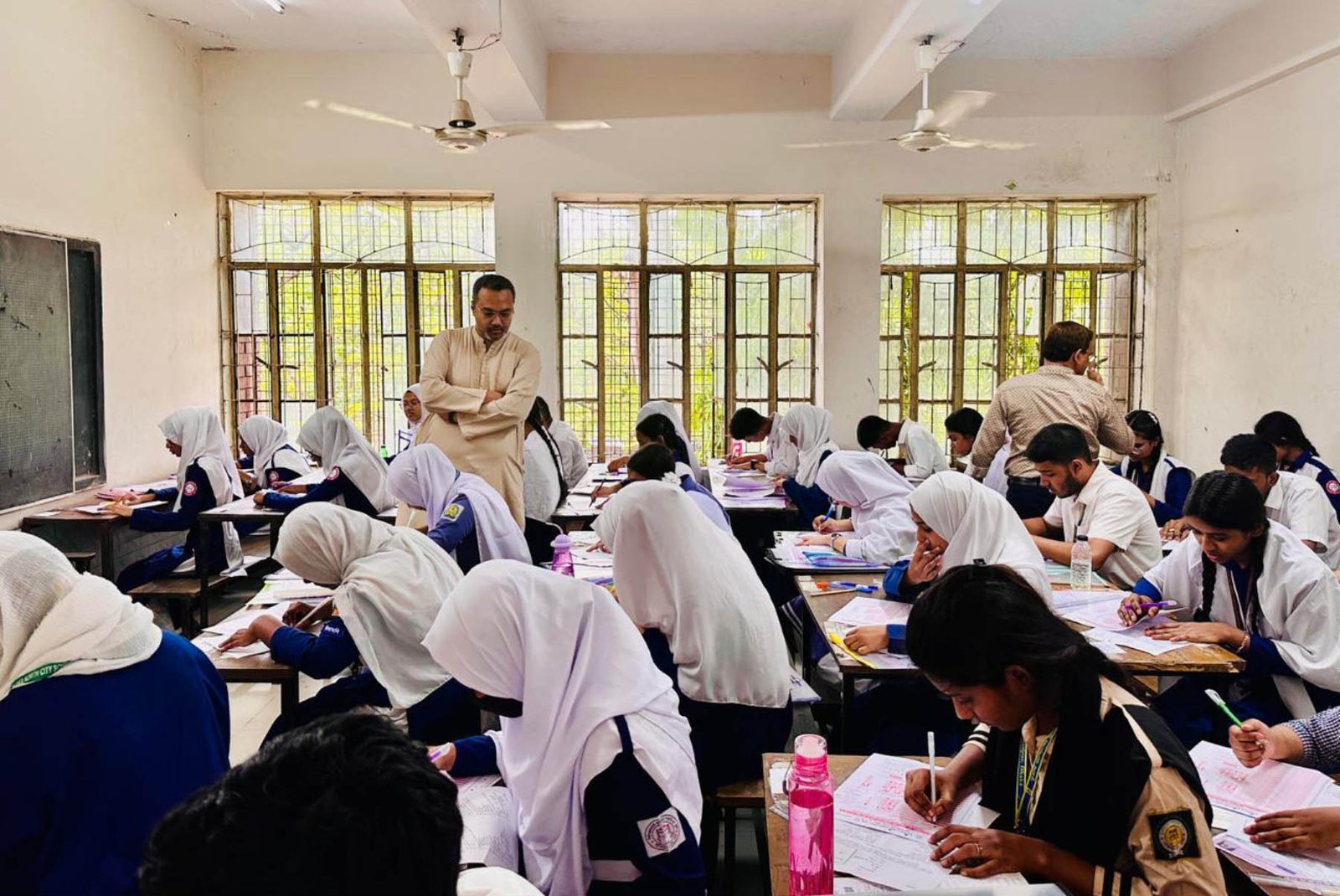 Students sit an SSC and equivalent examination at a Dhaka centre on 21 April 2026, during an inspection by Prime Minister's Adviser on Education Mahdi Amin.