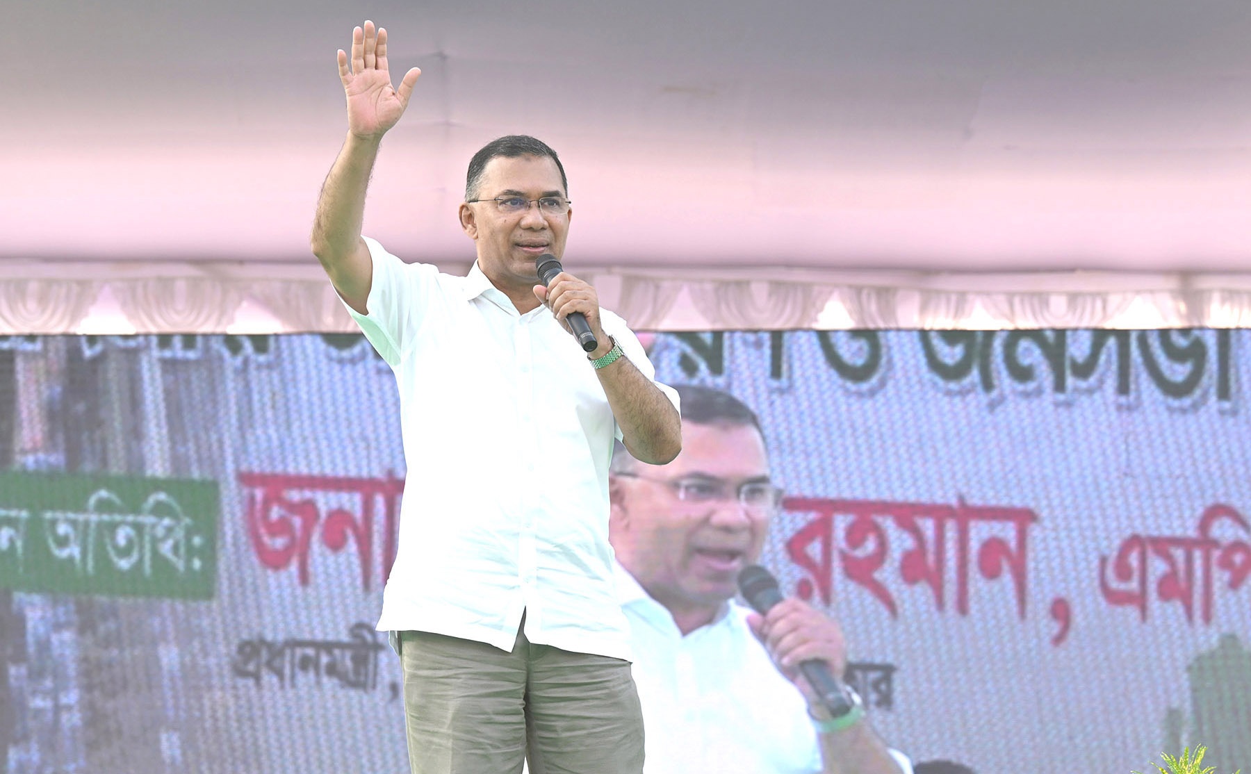 Prime Minister Tarique Rahman addresses a public meeting at Haji Muhammad Mohsin Government High School in Rajshahi on 20 October 2026, during the visit that preceded the arrest. Photo: Press Information Department, Government of Bangladesh, public domain, via Wikimedia Commons.