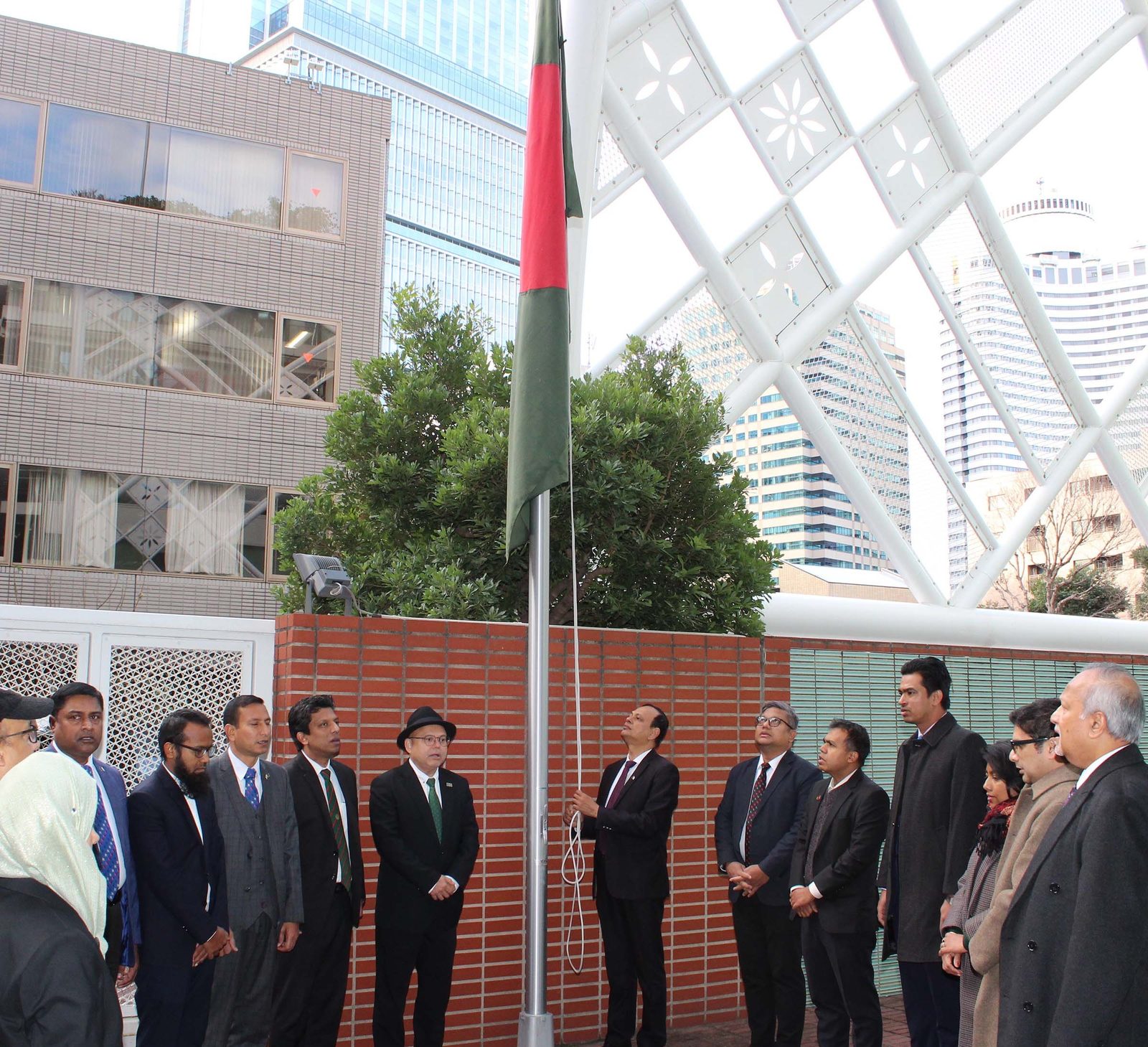 Bangladesh's ambassador to Japan, Md Daud Ali, hoisting the national flag at the embassy in Tokyo in December 2025, in a government file photo.