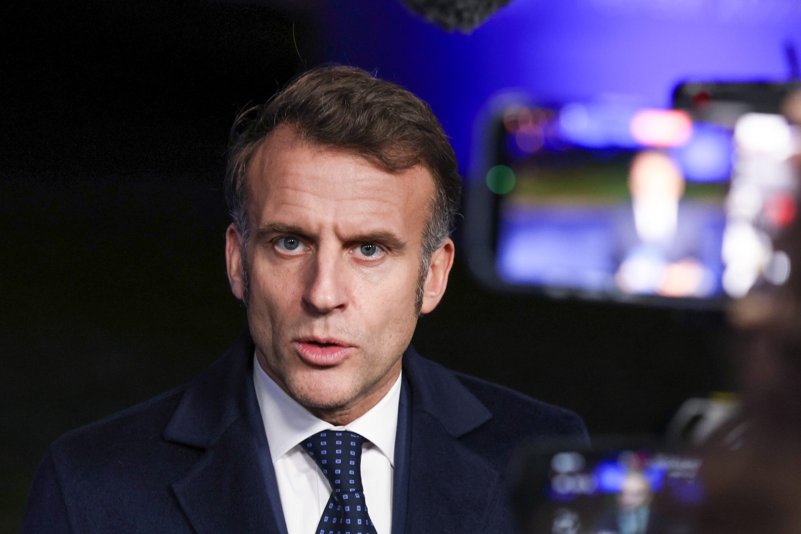 French President Emmanuel Macron speaks to journalists at microphones after a European Union leaders' meeting in Belgium in February 2026.