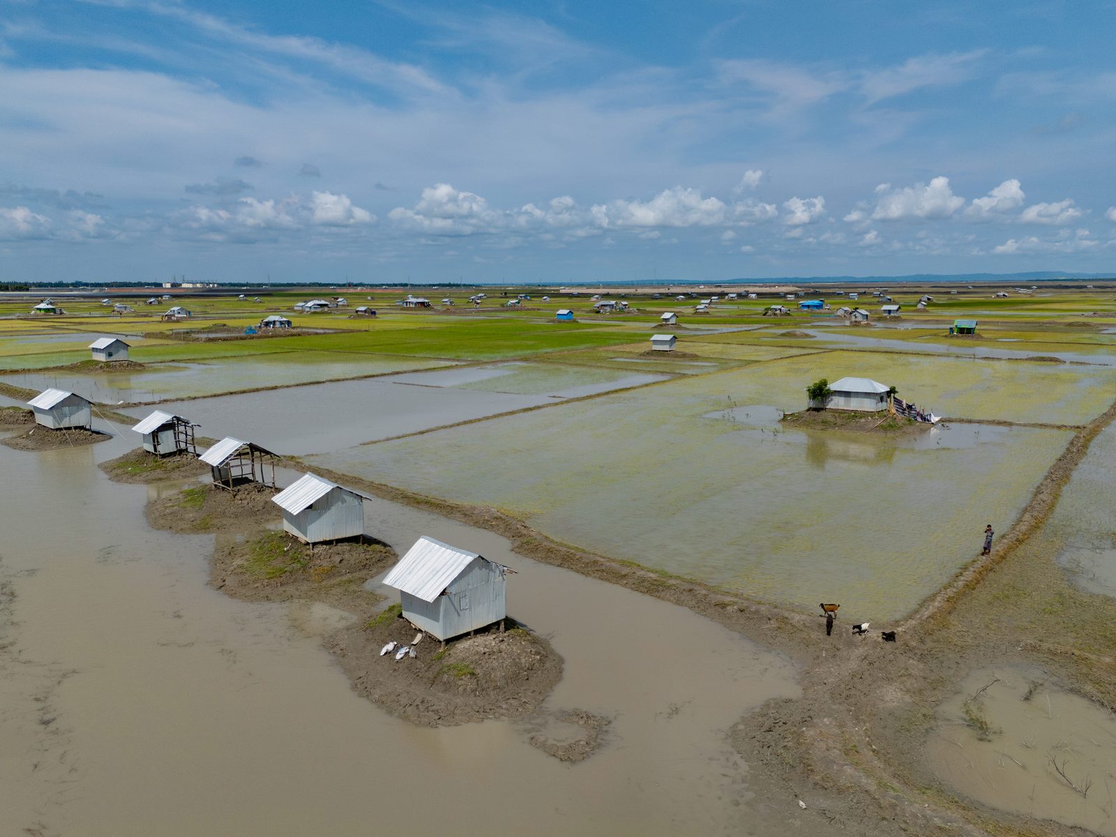 An aerial view of settlements surrounded by floodwater in Bangladesh, photographed on 15 August 2024. File photo illustrating the floods and other climate impacts the UN report warns will intensify as warming passes 1.5C.