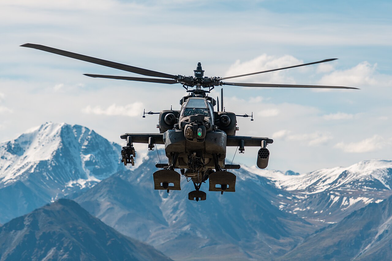 A US Army AH-64 Apache attack helicopter in flight over Alaska in 2019, in a file photo. Saudi Arabia operates Apache helicopters; a Houthi spokesman said the group shot down a Saudi Apache near Najran, while the Saudi-led coalition said a National Guard AH-6i reconnaissance helicopter crashed with a technical fault.